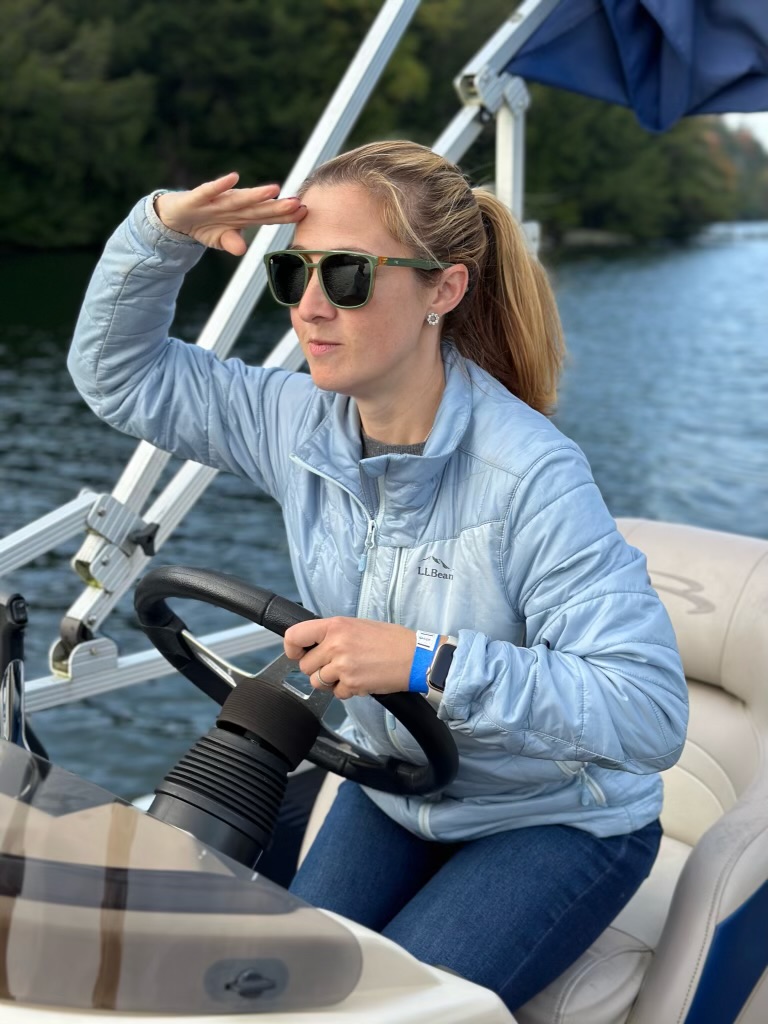 woman in sunglasses on a boat looking for something